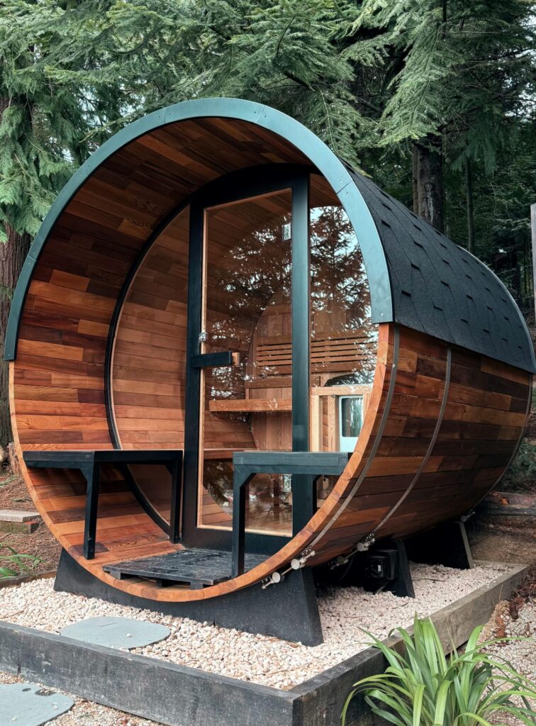 Rustic wooden barrel sauna located in serene forest of Hanmer Springs, New Zealand.